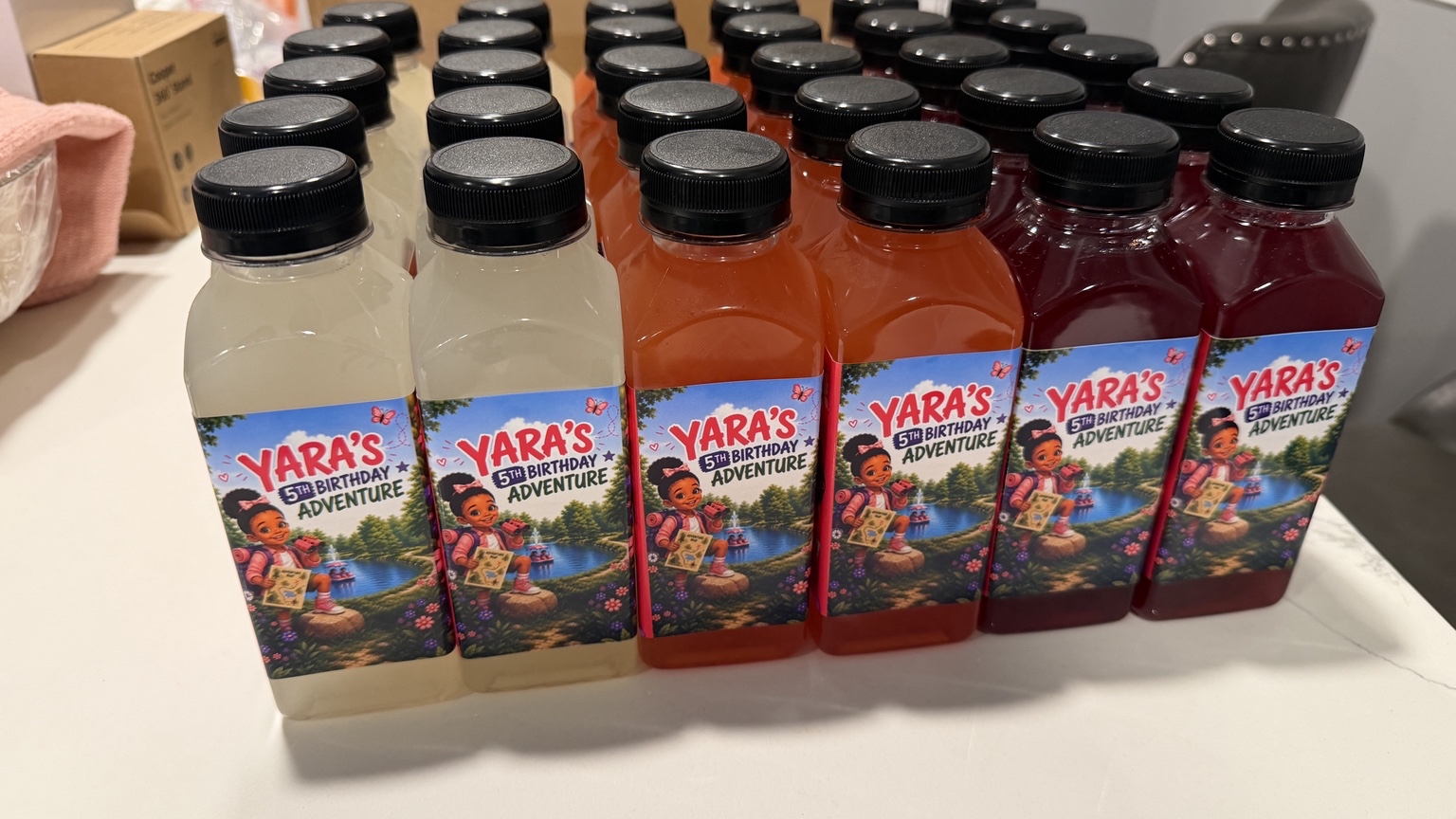 Rows of juice bottles with personalized birthday adventure labels