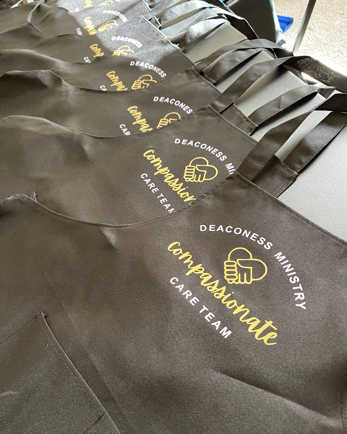 Ministry team aprons with gold branding